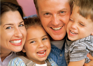 family smiling for photo