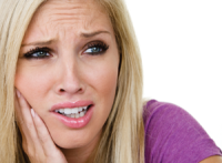 woman holding her jaw in pain