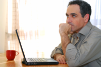 man thinking in front of computer