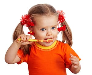 child brushing her teeth