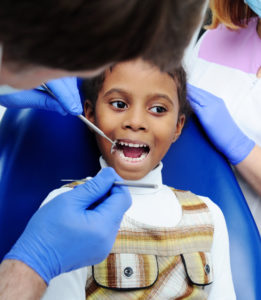 child participating in a dental exam