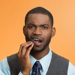 man suffering mouth pain from a cavity