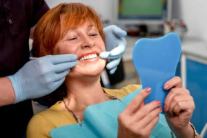 woman getting teeth examined